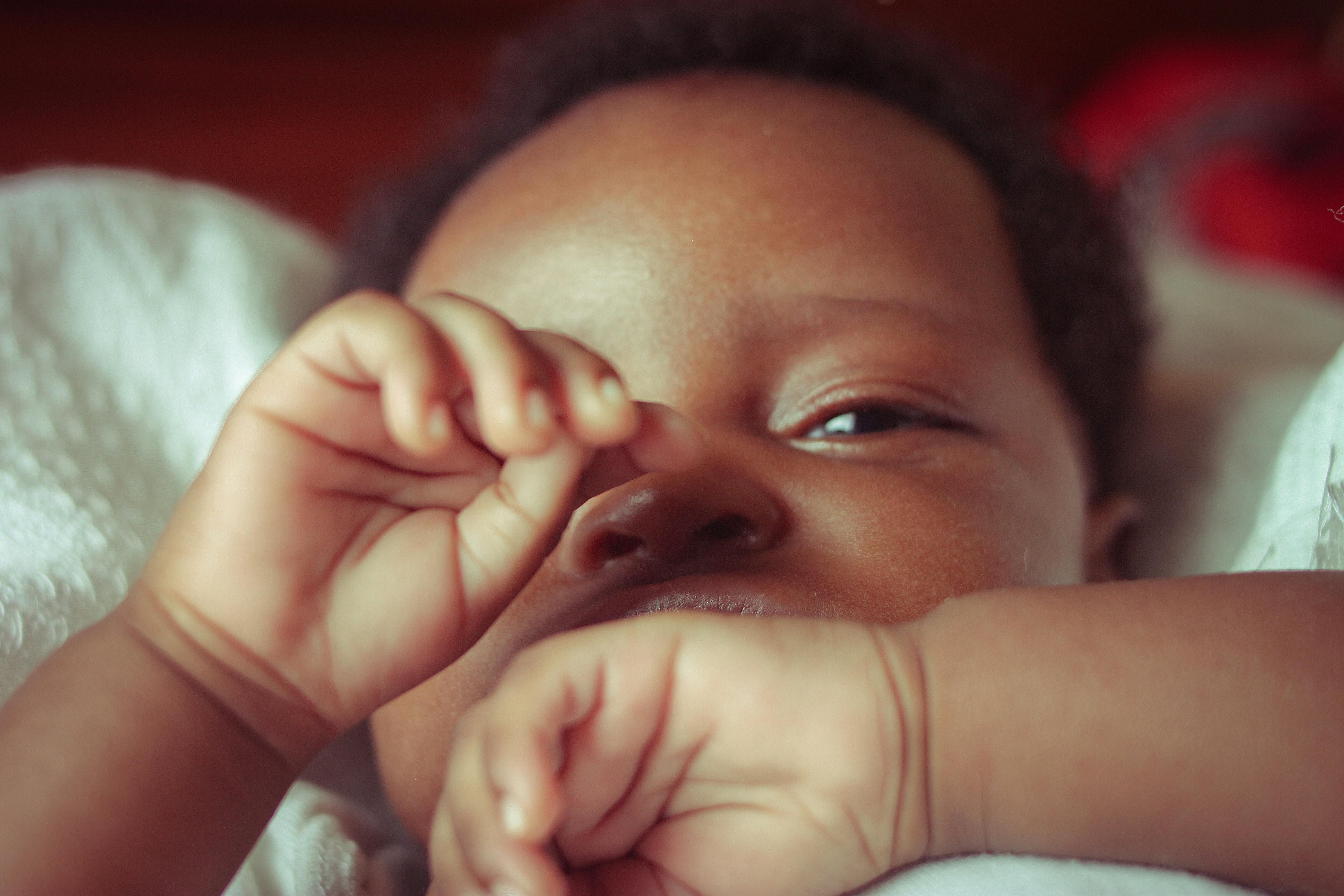 Adorable newborn baby sleeping peacefully, captured in a serene close-up shot from Jos, Nigeria.